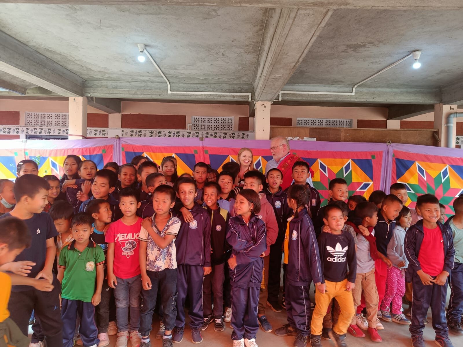 A large group of children gathered under the pavilion at Shalom Academy.