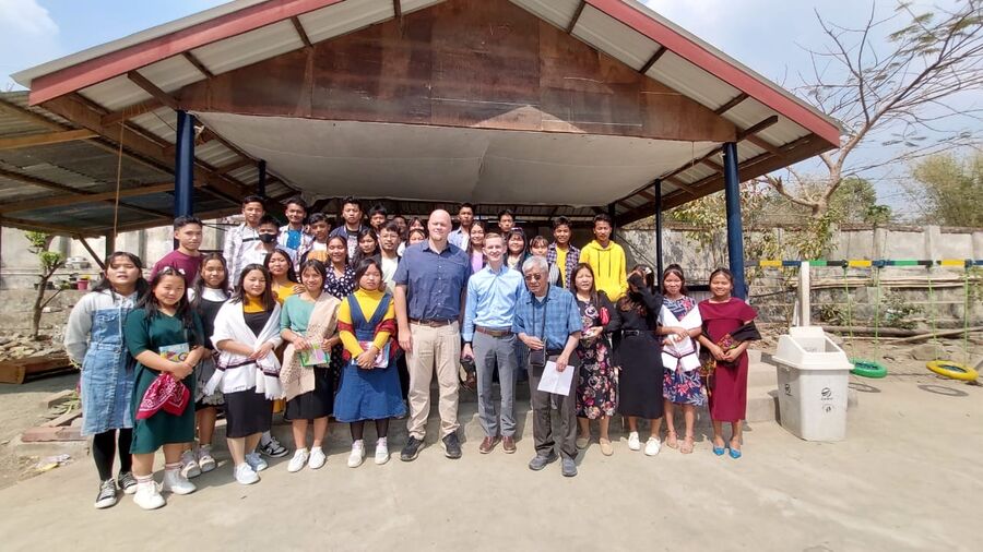 Students and staff gathered together under the pavilion.