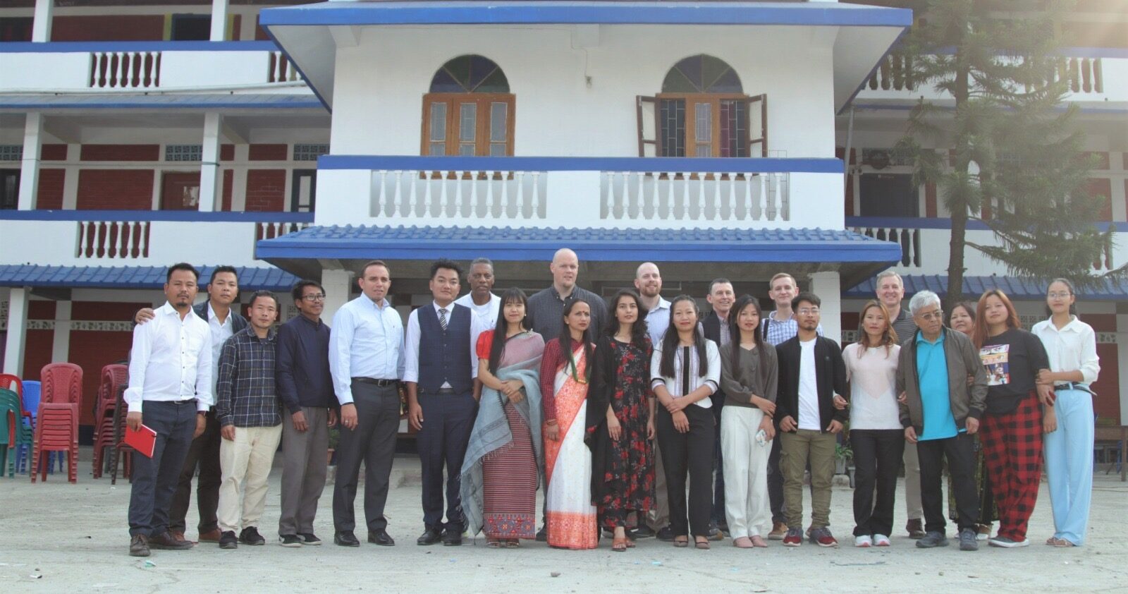 Staff and workers gathered in front of the main academy building.