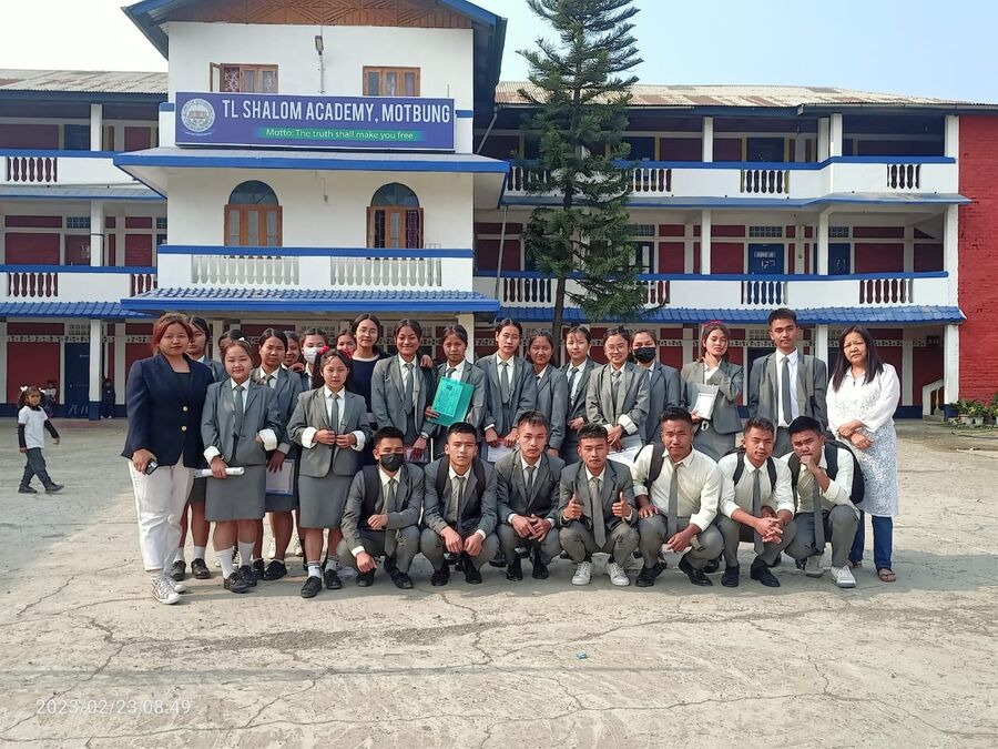 Students of T.L. Shalom Academy in uniform, gathered in front of the school building in Motbung.